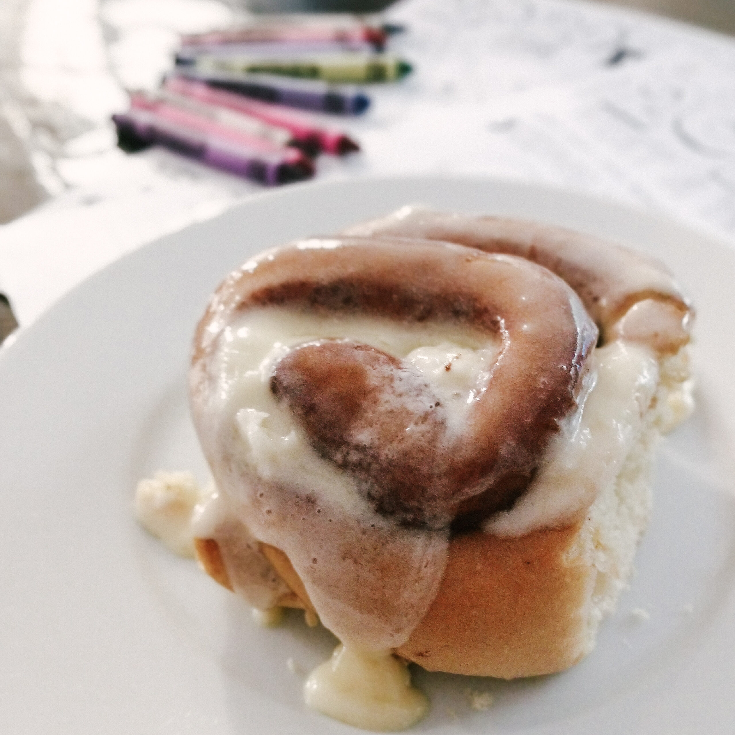 cinnamon roll with journaling supplies in background