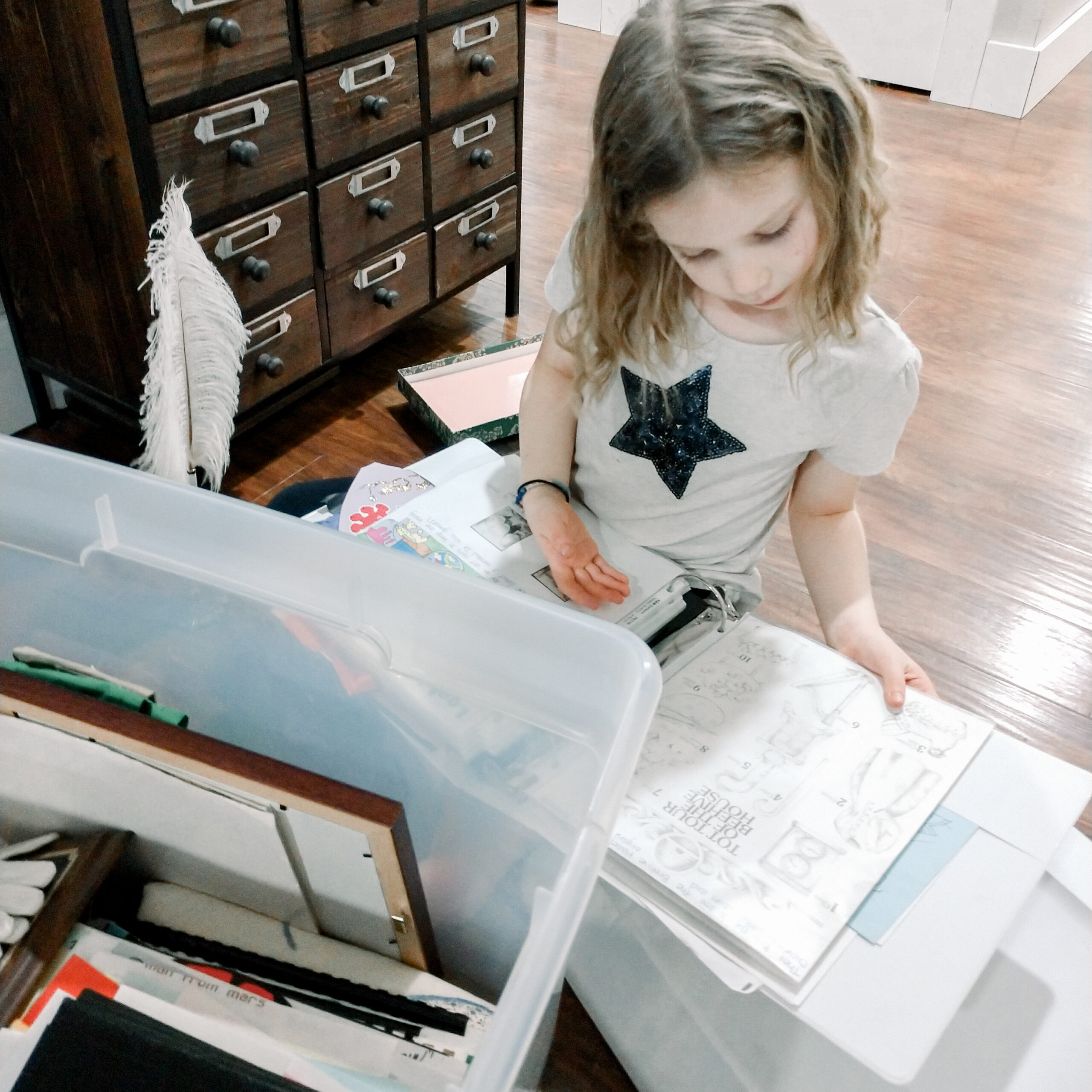 Kid looking through storage box of family memorabilia